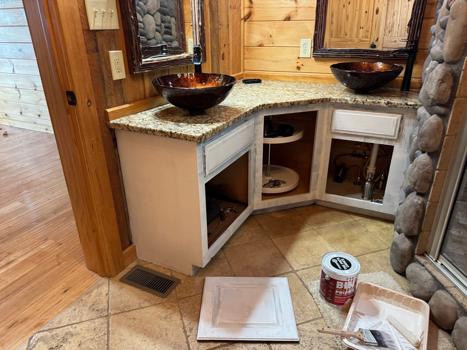 Cabin bathroom vanity with doors removed and cabinet boxes primed, before painting