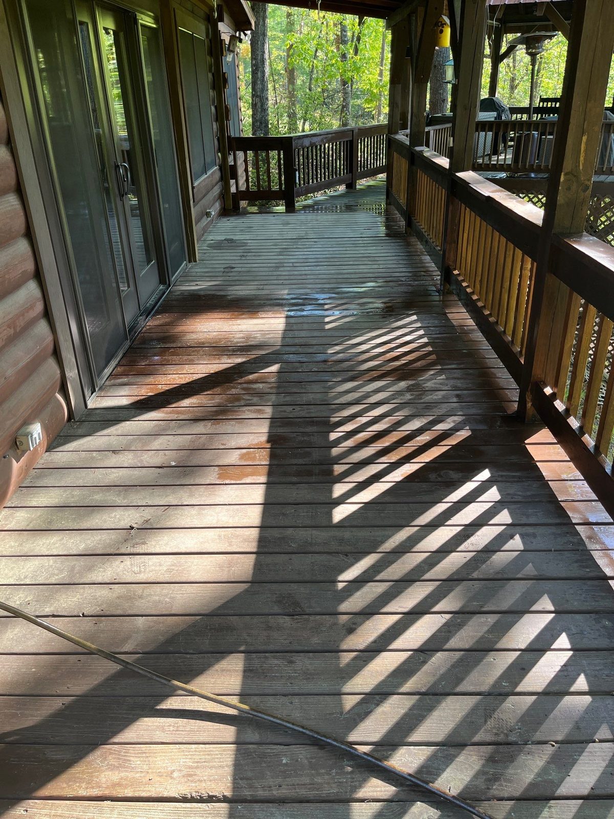 Faded gray deck boards before cleaning and staining in Cherry Log, GA