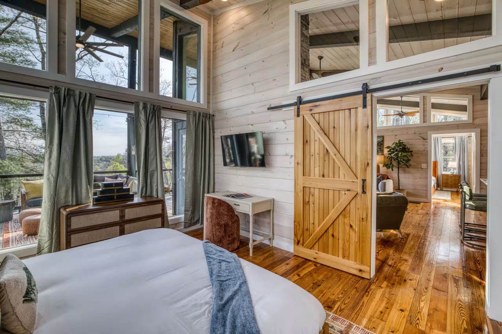 Sliding barn door in a whitewashed pine bedroom at a Morganton, GA cabin