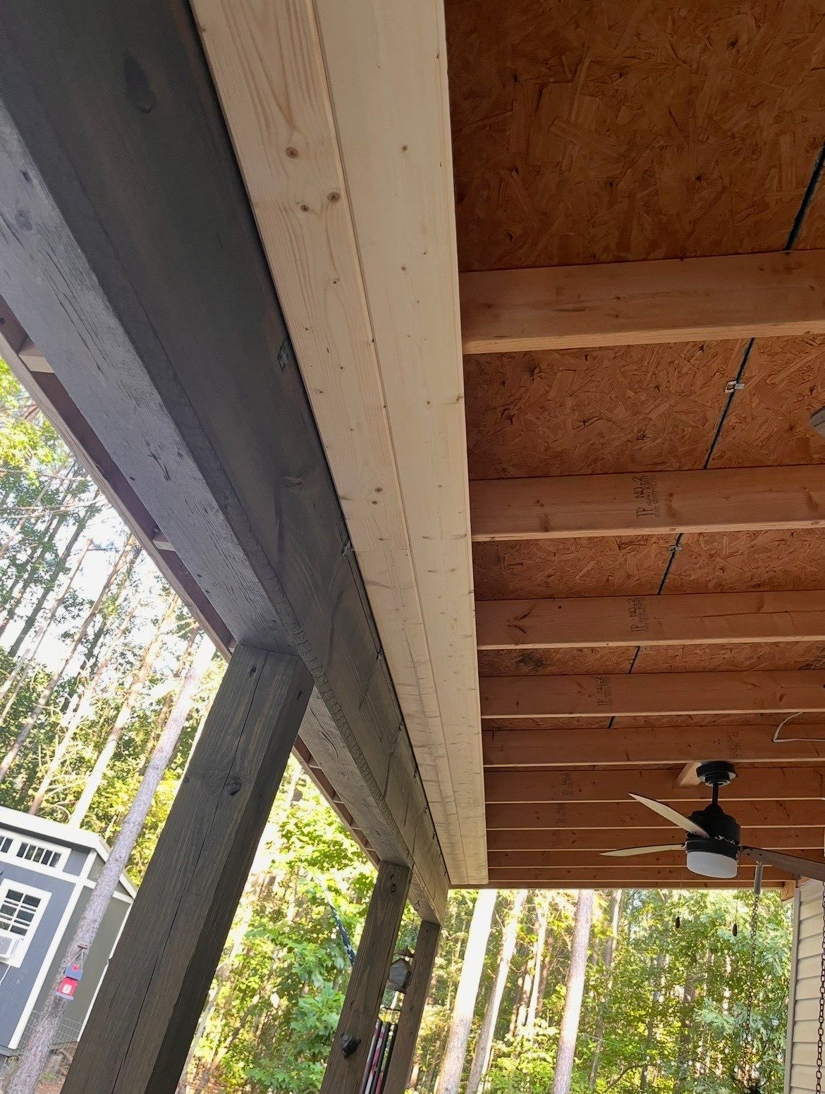 Covered porch in Talking Rock, GA with bare OSB roof decking and exposed joists before the ceiling was installed